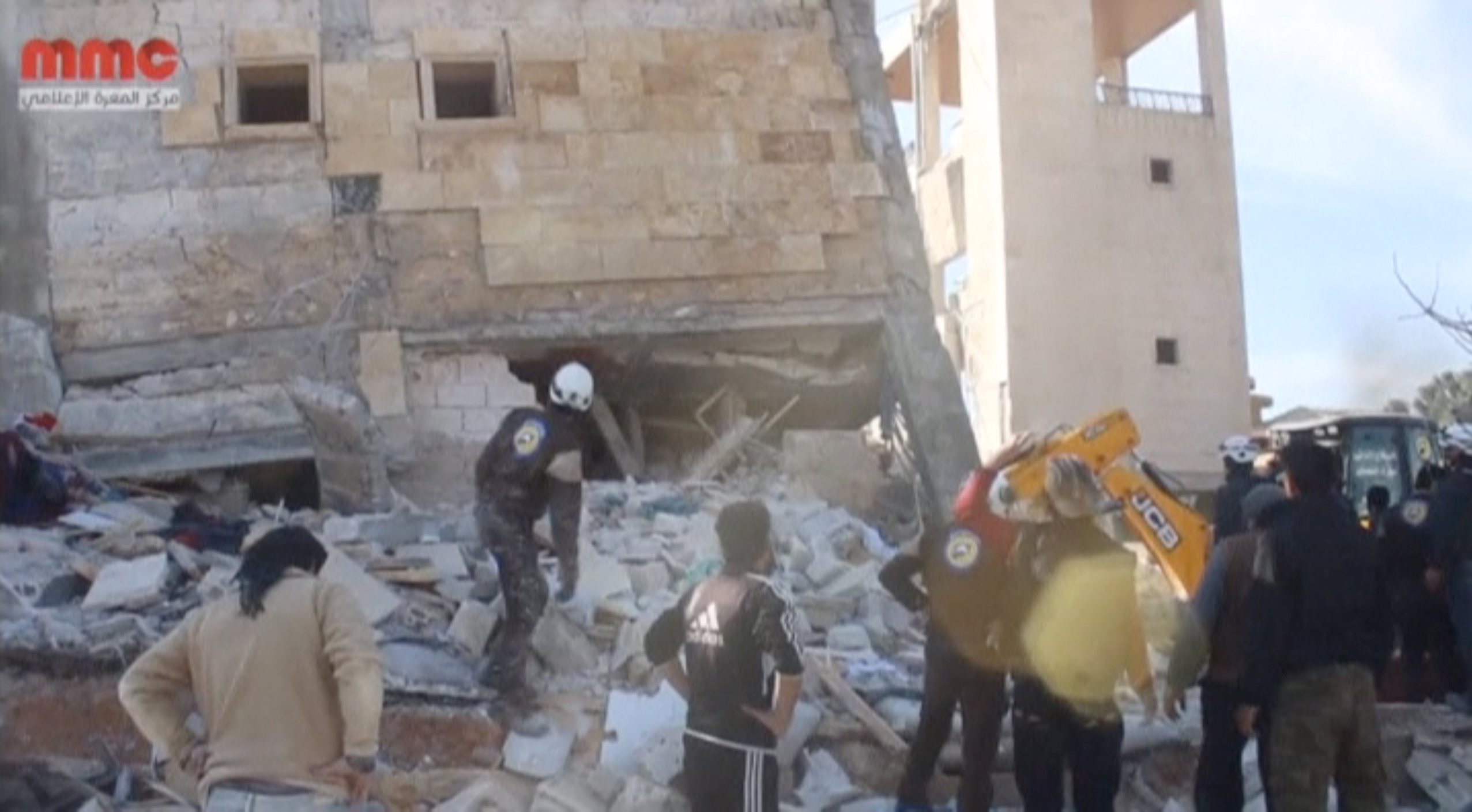 Still image taken from video shows people gathering near a destroyed building said to be a Medecins Sans Frontieres (MSF) supported hospital in Marat al Numan, Idlib, Syria